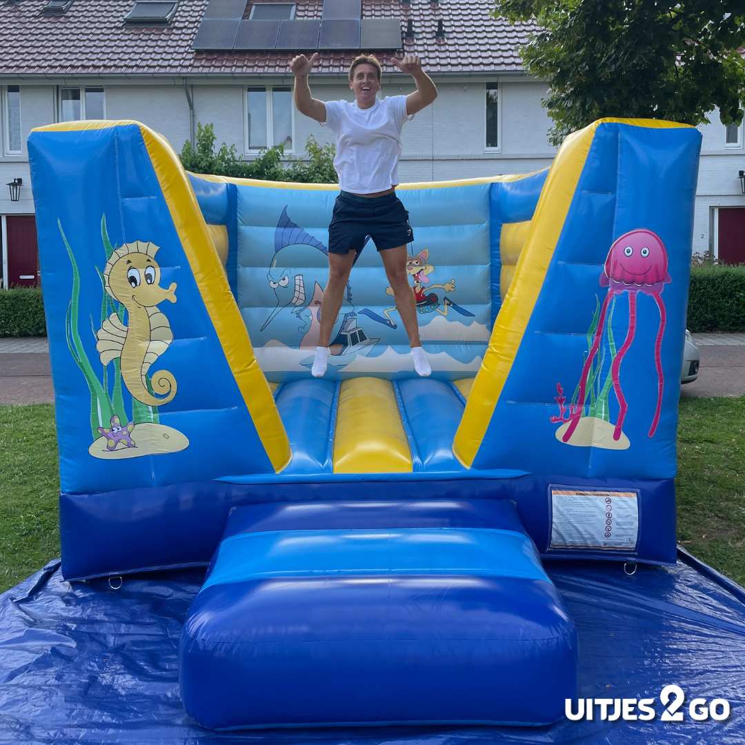 Springkussen Seaworld in de tuin met een springende bezoeker – verhuur door Uitjes2go in Ede